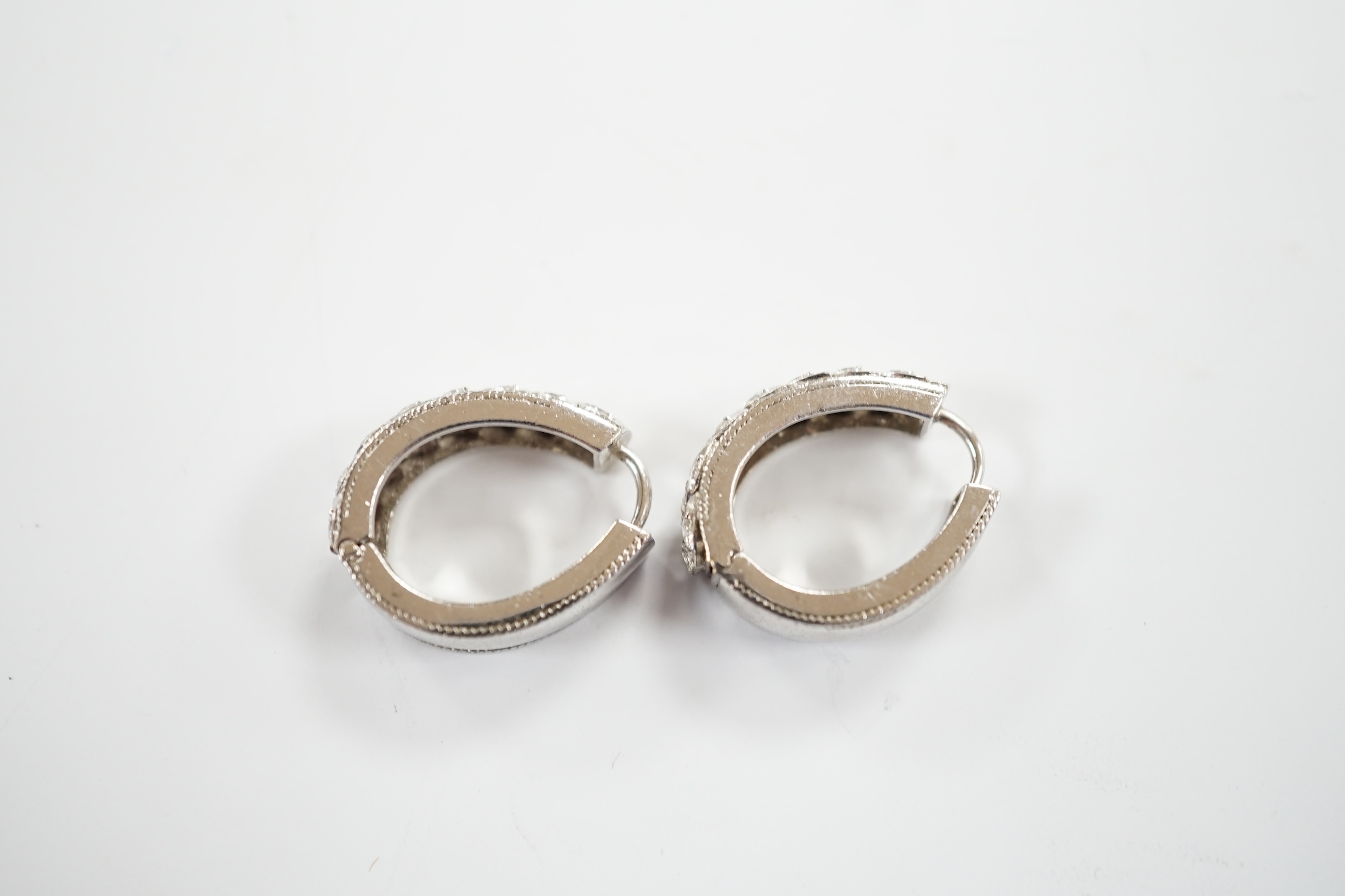 A modern pair of white metal and diamond cluster set half hoop earrings, 20mm, gross weight 8.9 grams.